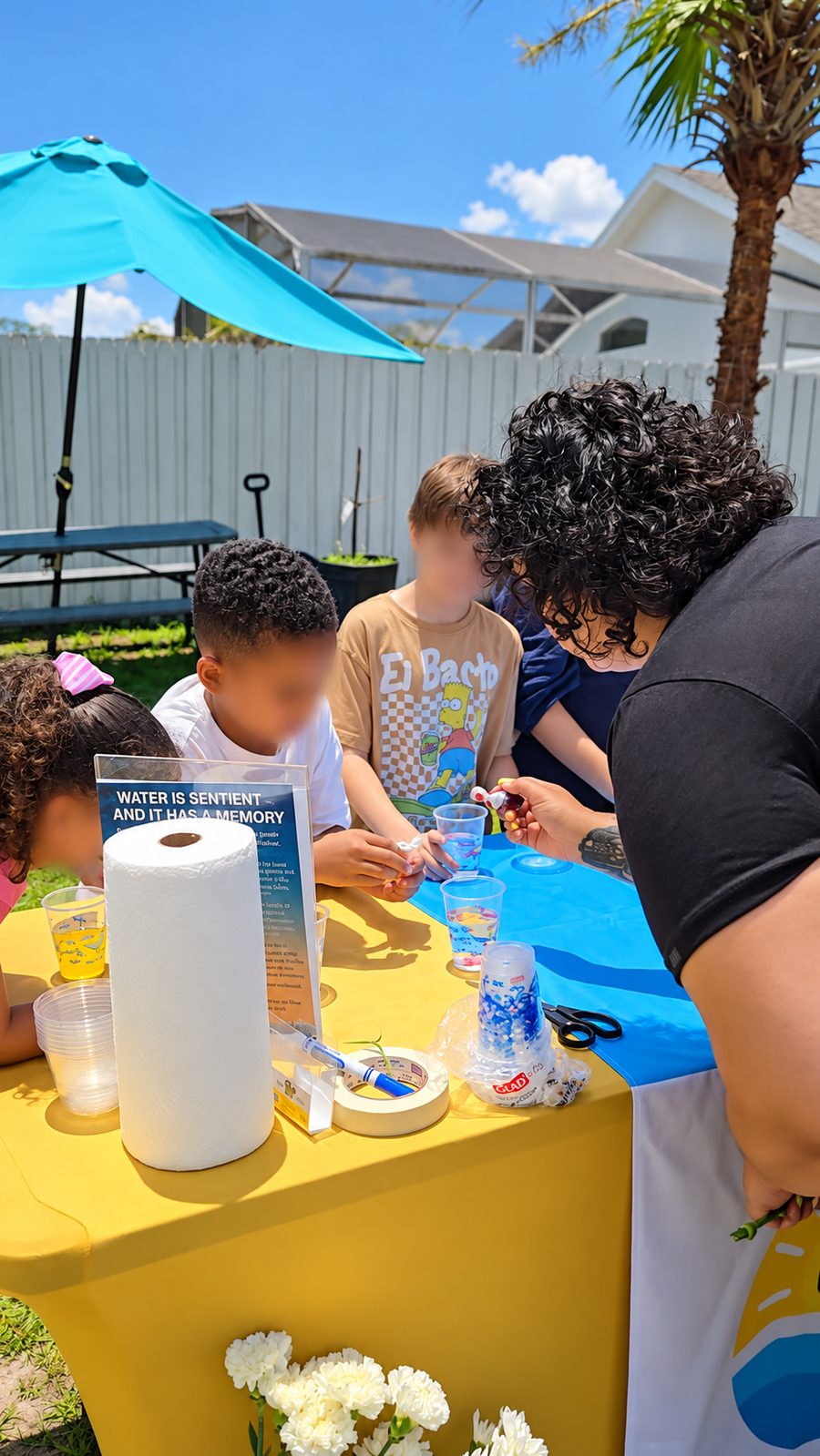 Students observing cups of colored water during a hands-on water activity
